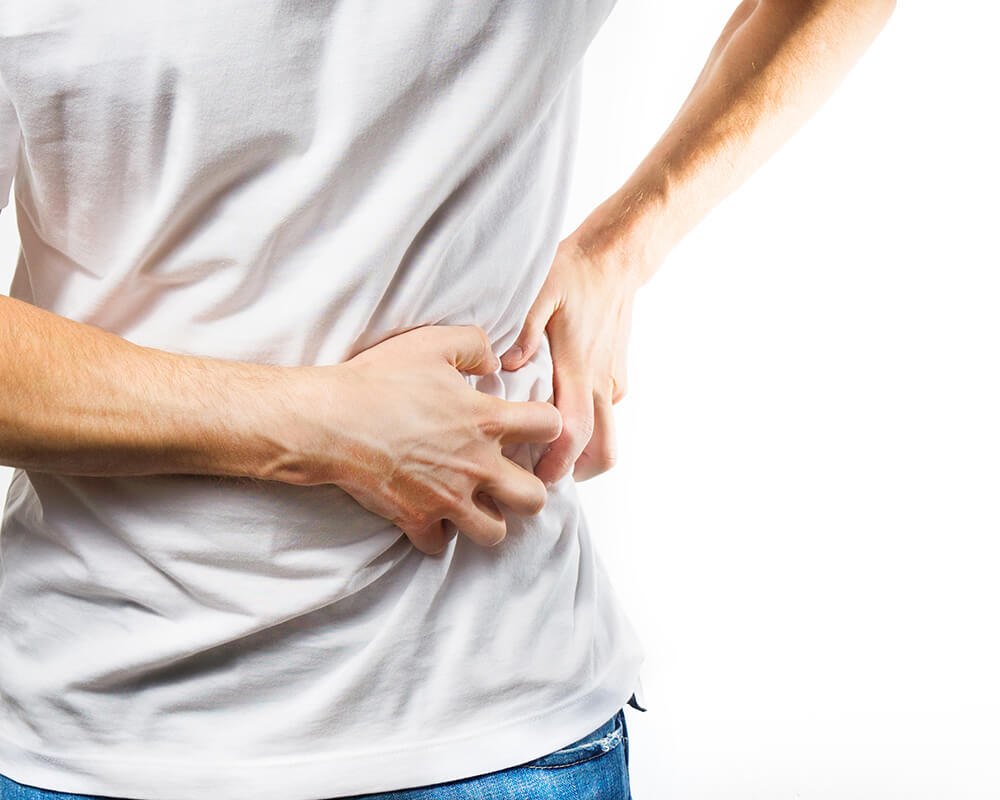 Someone in pain from kidney stones - learn how IV therapy can help in Wilmington, NC.
