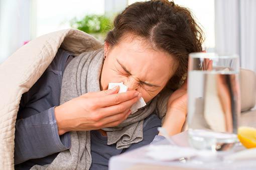 A woman feeling sick - learn how to prevent and treat common respiratory infections in Franklin, TN.