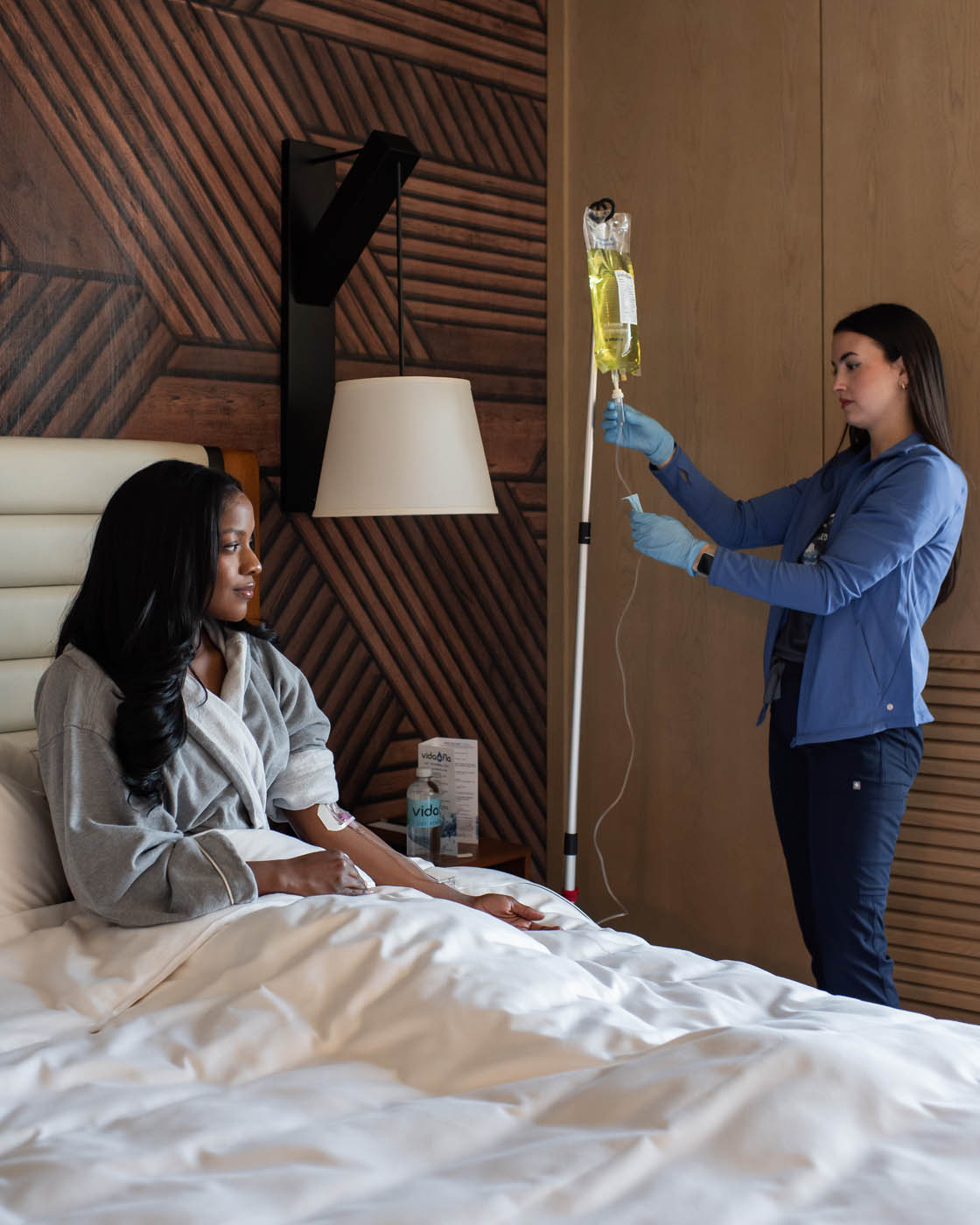 A woman in bed receiving home IV hydration from Vida-Flo Murfreesboro.