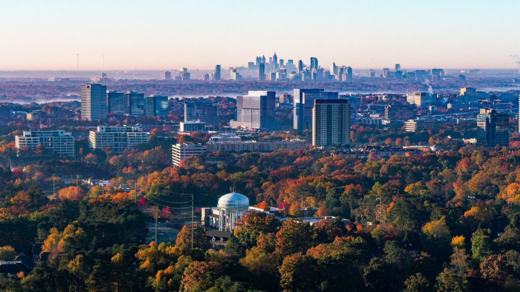 Dunwoody in fall color with the Perimeter Center towers and the Atlanta skyline in the distance