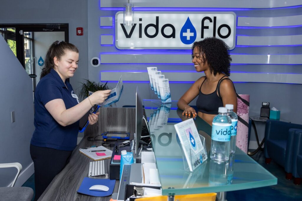 Guest checking in at the Vida-Flo front desk