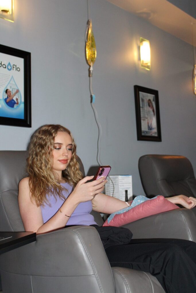 Guest relaxing in a Vida-Flo treatment recliner during her IV