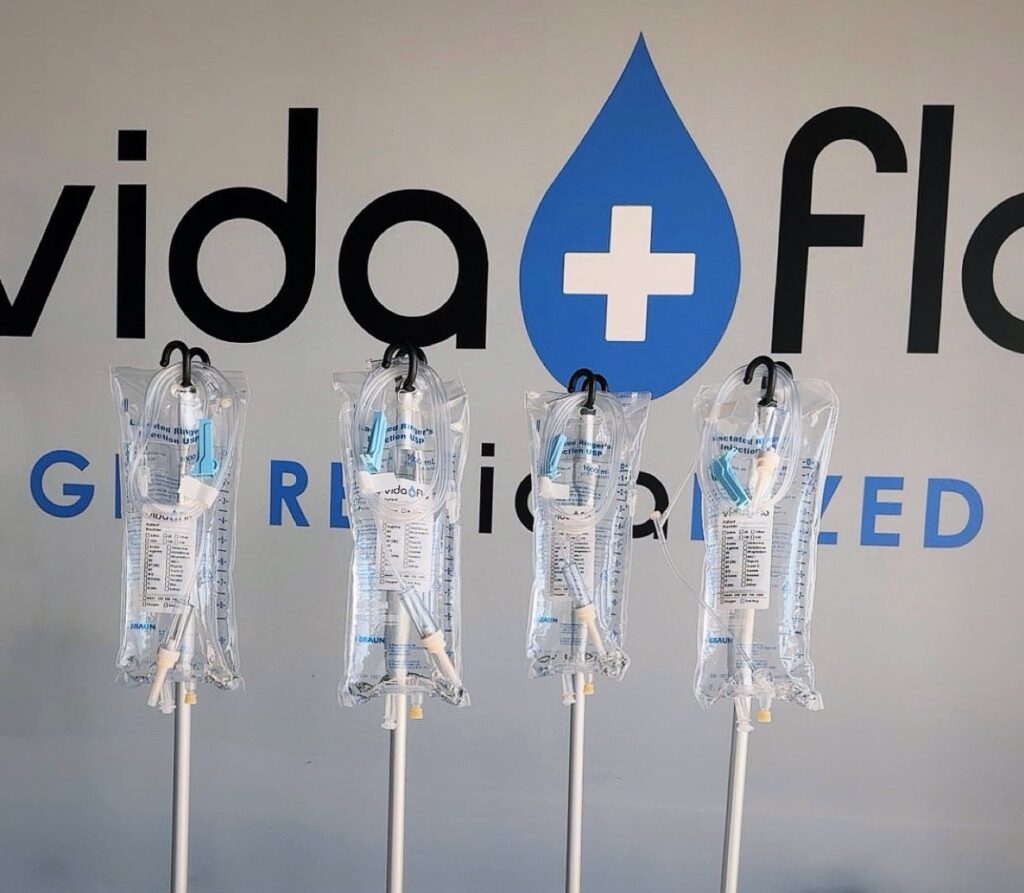 IV bags hung in front of the Vida-Flo logo wall at Vida-Flo Johns Creek