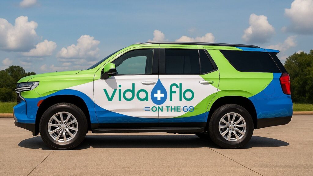 Vida-Flo On-The-Go vehicle, a Tahoe in the green and blue Vida-Flo wrap
