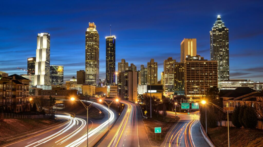 Downtown Atlanta skyline at blue hour with light trails on the highway